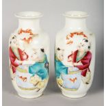 A PAIR OF SMALL 20TH CENTURY CHINESE REPUBLICAN PORCELAIN VASES, depicting figures in a landscape