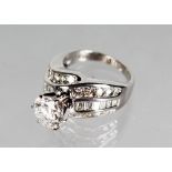 A VERY SUBSTANTIAL DIAMOND RING, with central stone of 2.4cts approx., surrounded by baguette and