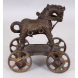 A 19TH INDIAN BRONZE TOY MODEL OF A HORSE, standing on a rectangular plinth supported by four moving