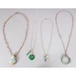 A GROUP OF FOUR CHINESE JADE ORNAMENT NECKLACES, with metal and bead strands, one necklace with a