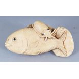 A JAPANESE MEIJI PERIOD IVORY NETSUKE OF TWO FISH & A SQUID, the details naturalistically carved,