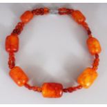 AN UNUSUAL AMBER NECKLACE, weighing 73gm in total, composed of large oblong beads connected by