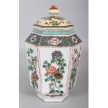 A 19TH CENTURY CHINESE KANGXI STYLE FAMILLE VERTE HEXAGONAL SECTION PORCELAIN VASE & COVER,