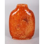 A 19TH/20TH CENTURY CHINESE AMBER SNUFF BOTTLE, weighing approx. 39.4gm, 2.7in high.