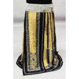 A 19TH CENTURY CHINESE YELLOW GROUND EMBROIDERED SILK SKIRT, the waist band approx. 49in wide, the