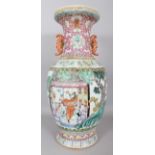 A LARGE EARLY 20TH CENTURY CHINESE FAMILLE ROSE PORCELAIN VASE, the sides painted with a