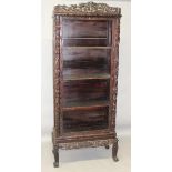 A 19TH/20TH CENTURY CHINESE CARVED HARDWOOD DISPLAY CABINET ON STAND, with three shelves, the