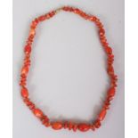 AN AGATE NECKLACE, composed of irregularly formed beads divided by small metal beads, approx. 23in