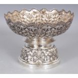 A CHINA STRAITS EMBOSSED SILVER-METAL BOWL, supported on a splayed stepped foot, weighing approx.