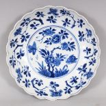 A GOOD QUALITY CHINESE KANGXI PERIOD BLUE & WHITE LOBED PORCELAIN DISH, circa 1700, painted to the