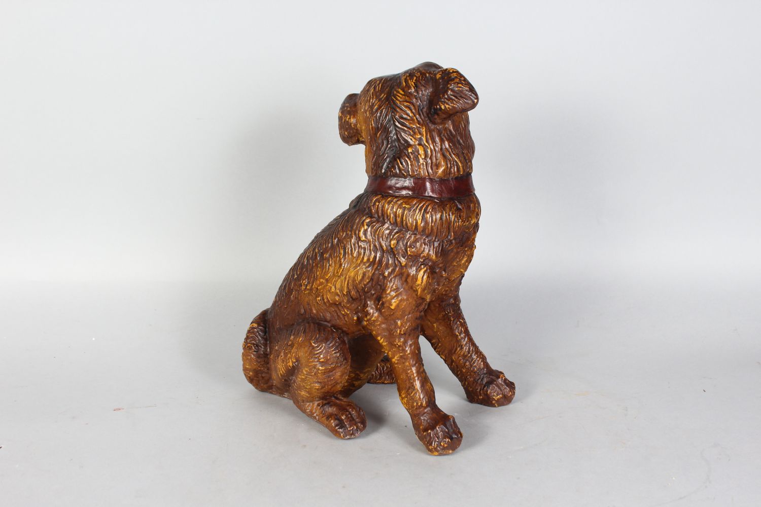 A 19TH CENTURY MOULDED POTTERY MODEL OF A SEATED DOG, with amusing expression and glass eyes. - Image 2 of 2