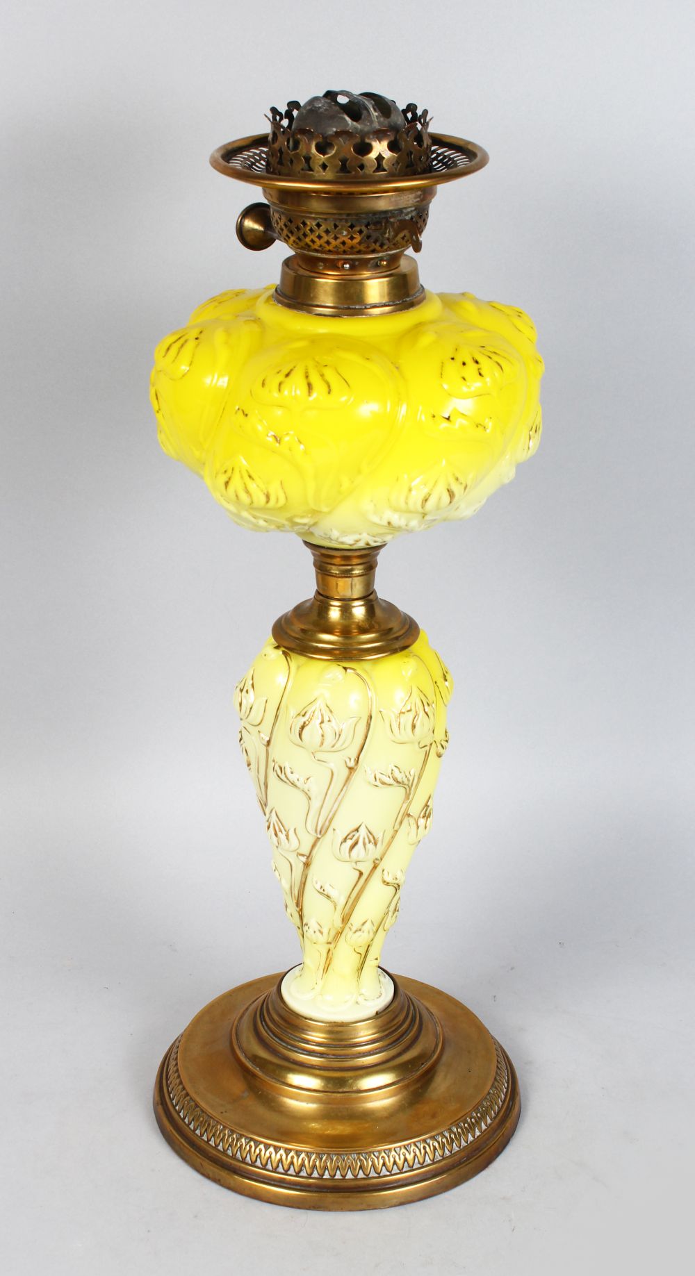 A GOOD VICTORIAN YELLOW MILK GLASS OIL LAMP on a brass base. 19ins high.