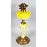 A GOOD VICTORIAN YELLOW MILK GLASS OIL LAMP on a brass base. 19ins high.