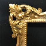 20th - 21st Century English School Style. A Carved Giltwood Swept Pierced Centres and Corners Frame,