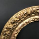 19th Century French School. A Carved Giltwood Oval Frame, 14.25" x 11" (rebate).