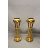 A PAIR OF GILTWOOD TORCHERES, with marble tops and rams head decoration. 3ft 10ins high.