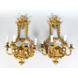 A VERY GOOD PAIR OF GILT BRONZE FOUR LIGHT WALL SCONCES with scrolling arms. 24ins long.