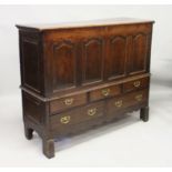A LARGE 18TH CENTURY OAK FIVE DRAWER MULE CHEST, hinged top over panelled decoration, three short