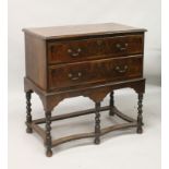 AN 18TH CENTURY WALNUT CHEST ON STAND, two drawers above a scalloped stretcher and base, raised on