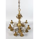 A BRASS TWO TIER TWELVE LIGHT CHANDELIER. 20ins high.