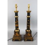 A PAIR OF BLACK TOLE WARE COLUMN LAMPS. Each 2ft high.