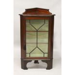 AN EDWARDIAN INLAID MAHOGANY STANDING CORNER CABINET, on bracket feet. 3ft 6ins high x 2ft 0ins wide