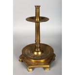 A VERY EARLY 16TH-17TH CENTURY BRASS CANDLESTICK, with circular stem, drip pan on a two tier