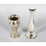 A .800 SILVER WRYTHEN FLUTED VASE and A .835 SILVER VASE (2).