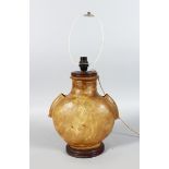 AN UNUSUAL ANIMAL SKIN LAMP, of bulbous twin handle shape, on a turned wood base. 13ins high.