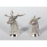 A PAIR OF SILVER STAGS HEAD SALT AND PEPPER.