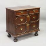 A SMALL 18TH CENTURY OAK STRAIGHT FRONT CHEST of two small and two deep drawers with brass