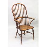 AN 18TH CENTURY WINDSOR ELM AND OAK ARMCHAIR with crinoline stretcher.