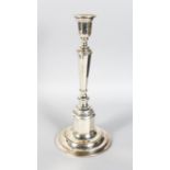 A TALL CONTINENTAL .800 SILVER CANDLESTICK on a stepped circular loaded base. 13ins high.