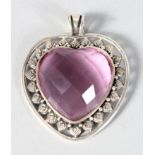 A SILVER AND FACET CUT GLASS HEART PENDANT.