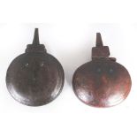 TWO ORIENTAL LEATHER CLAD & METAL MOUNTED POWDER FLASKS, 6.1in & 6in wide. (2)