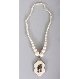 A JAPANESE MEIJI PERIOD MIXED METAL, IVORY & SILVER-METAL NECKLACE WITH PENDANT, the pendant in a