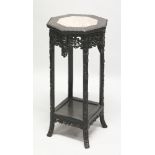 A 19TH CENTURY CHINESE PINK MARBLE TOP OCTAGONAL SECTION CARVED HARDWOOD STAND, the frieze pierced