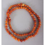 AN AMBER NECKLACE, weighing approx. 47.5gm, composed of spherical beads, approx. 36in long. (from