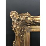 19th Century Continental School. A Gilt Composition Frame, with Swept and Pierced Centres and