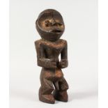 A CONGO CARVED WOOD TRIBAL FIGURE. 13.5ins high.