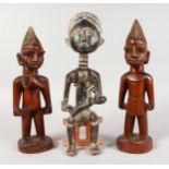 THREE AFRICAN WOODEN FIGURES. 12ins and 13ins high.