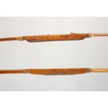 TWO EARLY LONG BOWS, bound leather and fibre grip. Longest: 6ft 2ins (2).