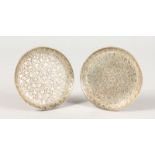 A PAIR OF SMALL ENGRAVED PERSIAN SILVER DISHES.