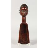 A TRIBAL CARVED WOOD SPOON SCOOP, the handle as a female head. 12ins high.