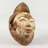 A CARVED AND PAINTED TRIBAL MASK. 13ins.