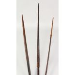 THREE PAPUA NEW GUINEA CARVED BARBED SPEARS. Longest: 8ft 3ins (3).