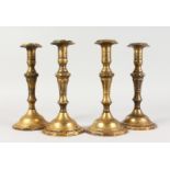 A SET OF FOUR 18TH CENTURY FRENCH CAST BRASS CANDLESTICKS. 10ins high.
