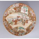 A JAPANESE CIRCULAR SATSUMA PLATE, painted with panels of figures and flowers. 7ins diameter.