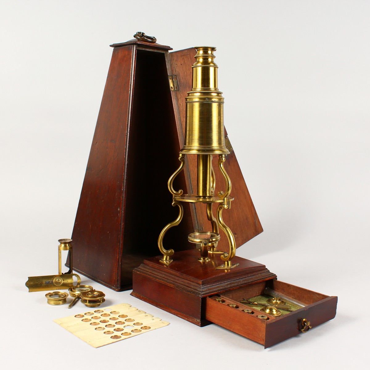 AN 18TH CENTURY BRASS CULPEPER MICROSCOPE by LINCOLN, LONDON, in an oak case, the sliding drawer