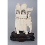 A LATE 19TH/EARLY 20TH CENTURY INDIAN IVORY CARVING OF AN ELEPHANT, together with a fixed wood